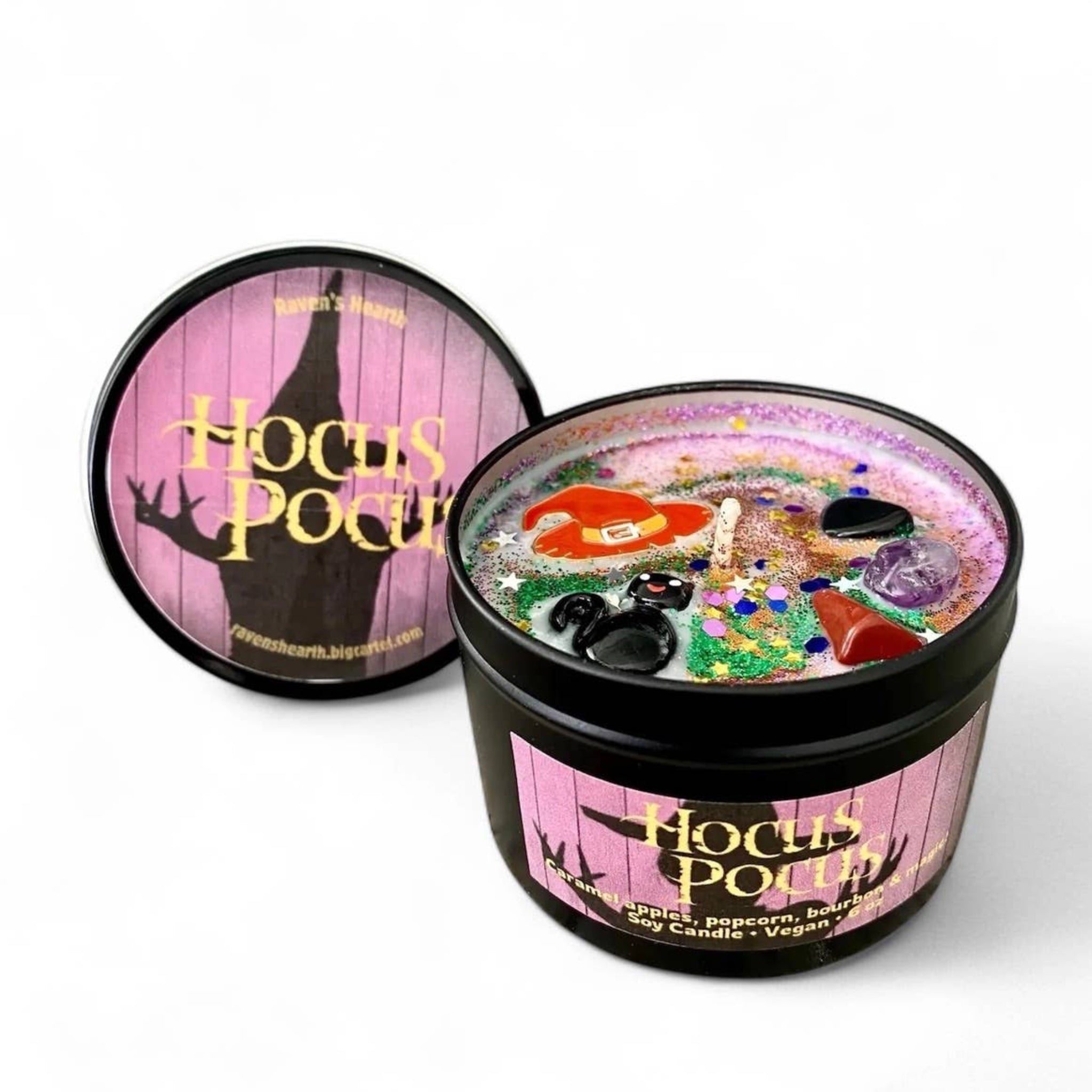 Candle with decorative elements and 'Hocus Pocus' branding on a white background