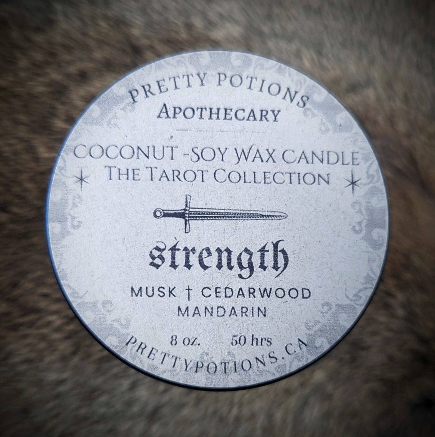 strength tarot card candle top with cedar wood and mandarin scent