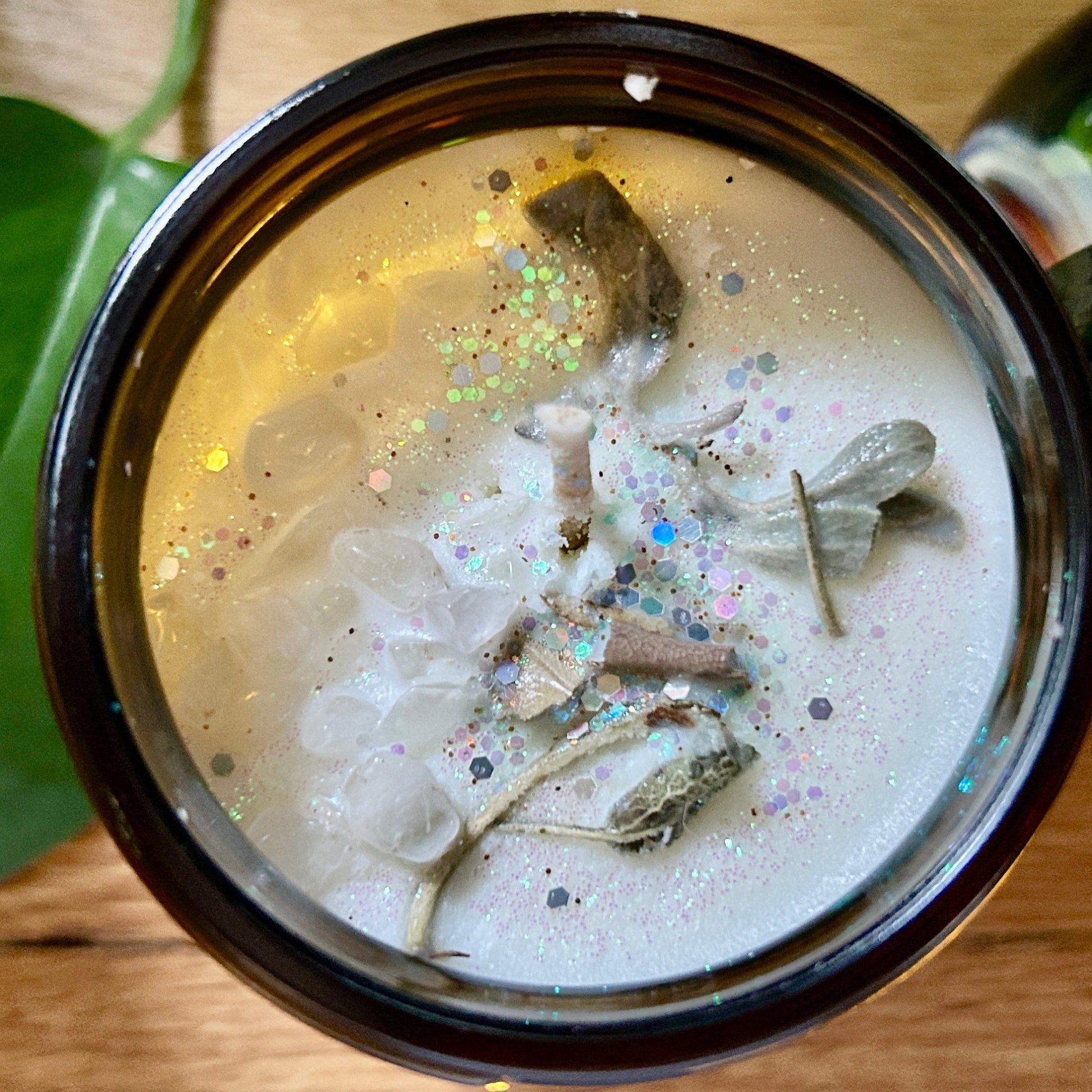 Close-up of a container with a white substance and dried herbs on a wooden surface