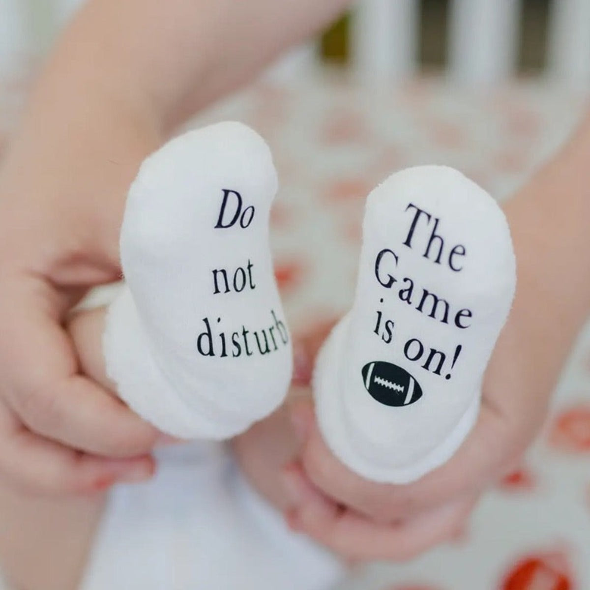 Baby sock do not disturb game is on baby feet